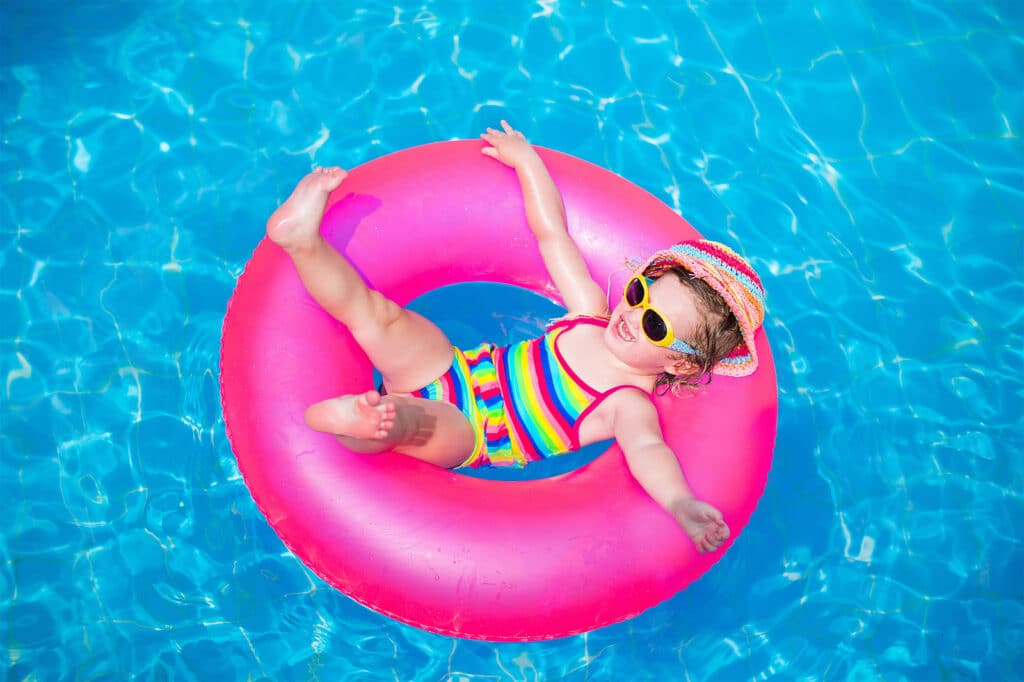 Cute Little Girl Playing In Swimming Pool